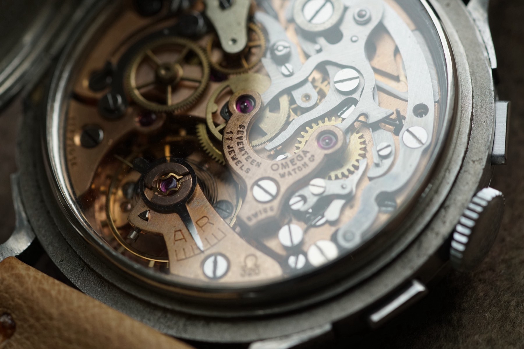 The Omega-signed Lemania 2310 architecture seen through the open officer caseback