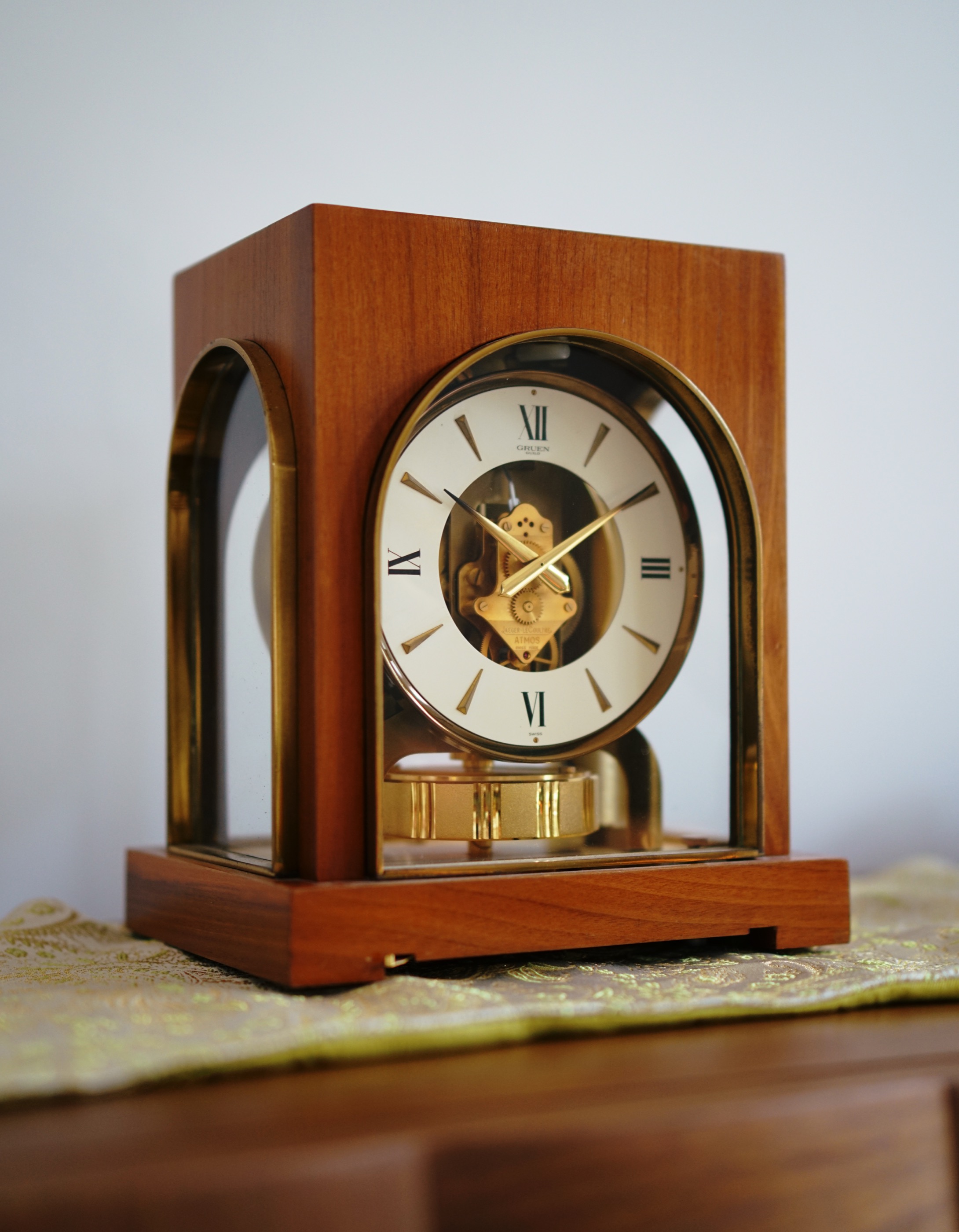 Jaeger-LeCoultre Atmos in a Gruen Guild Cosmos walnut cabinet photographed from the front
