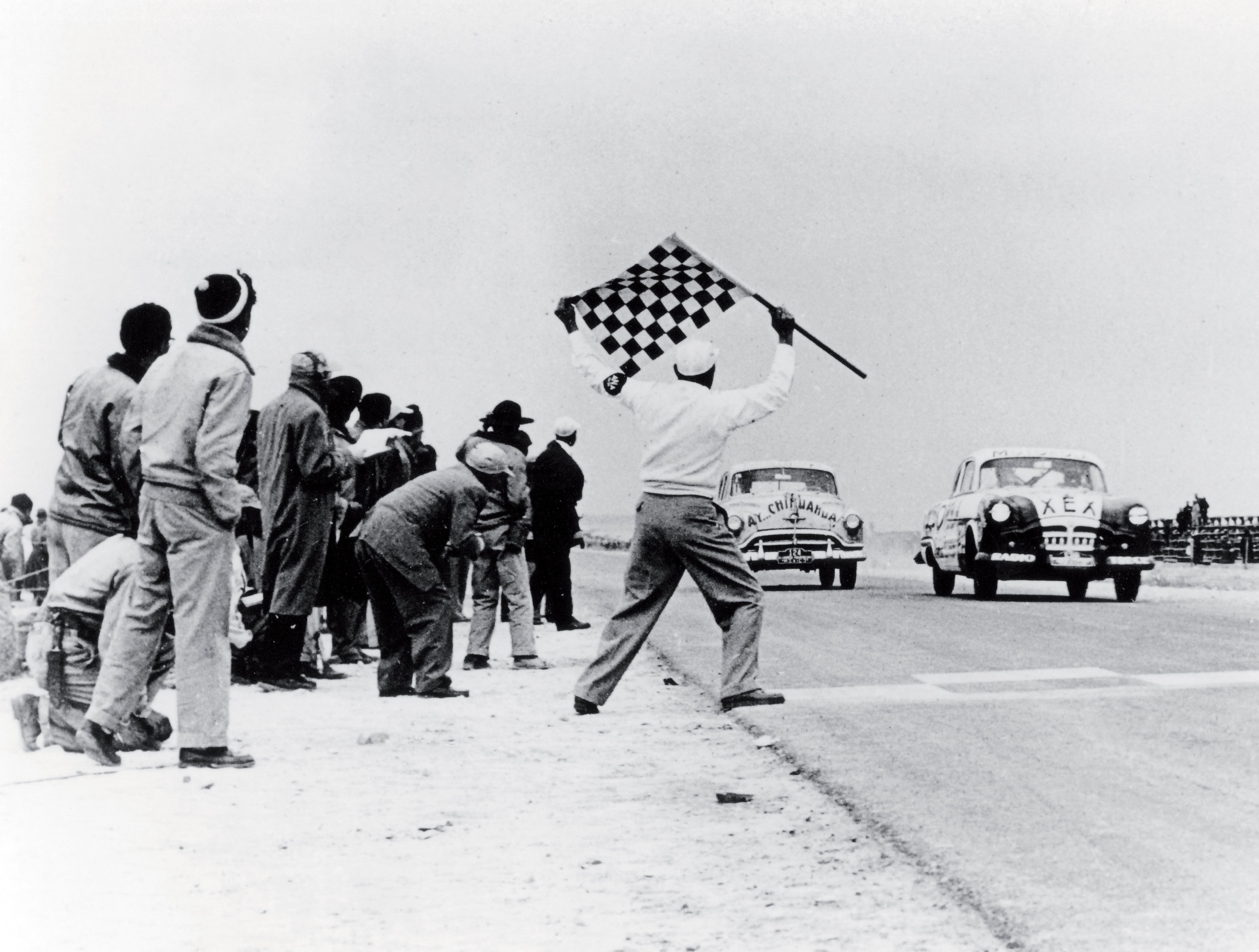 A car taking the chequered flag at the inaugural Carrera Panamericana in 1950